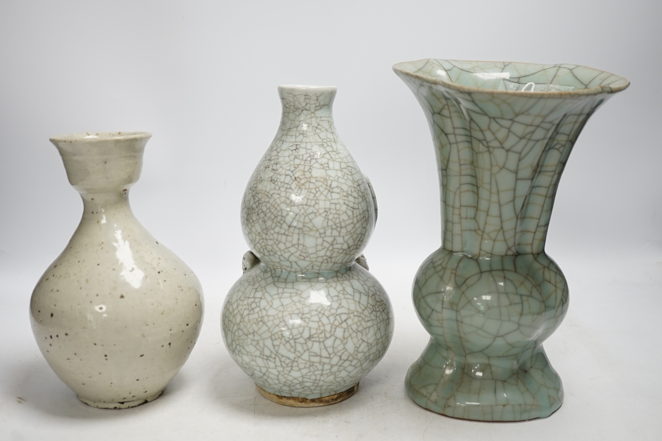 A Chinese underglaze blue and copper red lamp, two crackle glaze vases and a studio pottery bottle, largest 29cm high. Condition - fair